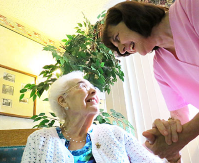 Nurse helping a woman up