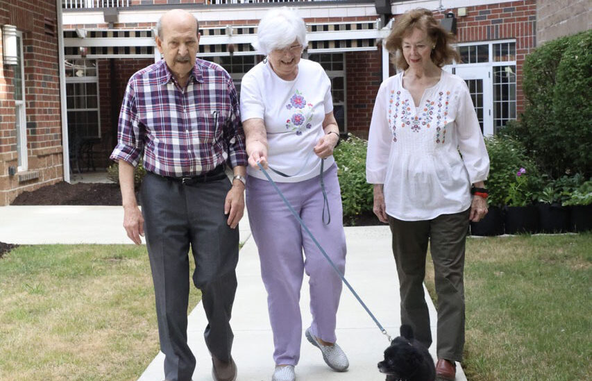 Residents walking with a dog outside Concordia of Bridgeville