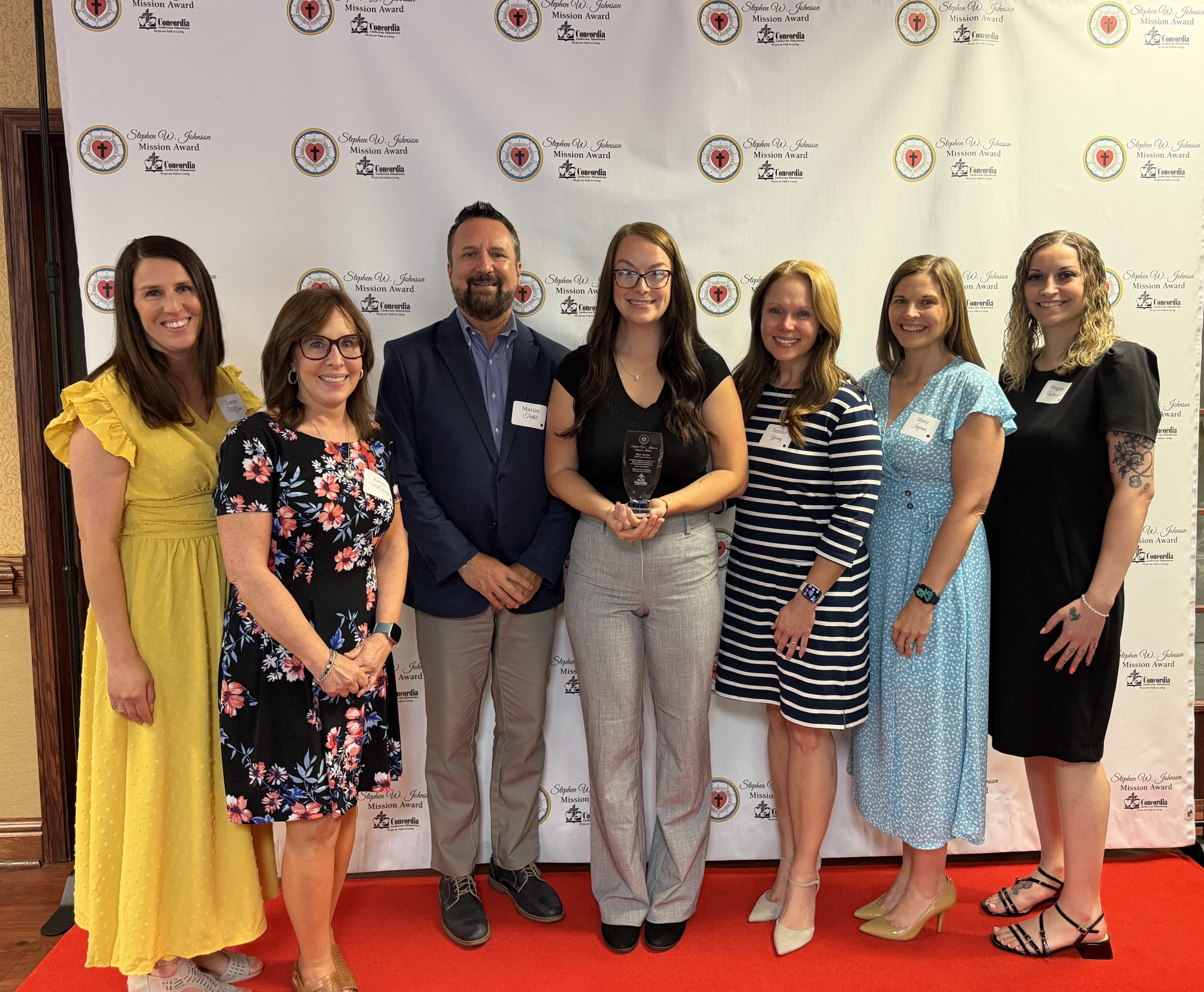 Mya Varner, 2026 Stephen W. Johnson Mission Award winner, flanked by Concordia's Home and Community Services leadership team